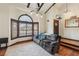 Comfortable living room features hardwood floors, a plush rug, and an arched window for natural light at 6712 Kittery Dr, Las Vegas, NV 89107