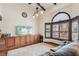 Cozy living room features hardwood floors, a wall-mounted TV, and an arched window at 6712 Kittery Dr, Las Vegas, NV 89107