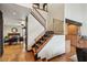 Elegant staircase with wooden steps and black railing, connecting to the dining room and living spaces at 6712 Kittery Dr, Las Vegas, NV 89107