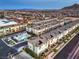 A stunning aerial perspective of a community featuring modern residences, a refreshing pool, and mountain views at 6821 Prairie Pearl St, Las Vegas, NV 89148