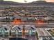 An aerial view showcases a community of modern townhomes with solar panels at sunset at 6821 Prairie Pearl St, Las Vegas, NV 89148