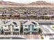 Aerial view of modern townhomes with solar panels, set against a mountain backdrop at 6821 Prairie Pearl St, Las Vegas, NV 89148