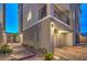 Charming home exterior with a well-lit garage, private balcony, and beautifully paved walkway at 6821 Prairie Pearl St, Las Vegas, NV 89148