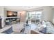 Bright living room with a large sliding glass door to a balcony, modern furniture, and stylish decor at 6821 Prairie Pearl St, Las Vegas, NV 89148