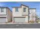 Inviting two-story home with an attached garage, landscaped front yard, and modern architectural design at 7017 Magenta Moon St, North Las Vegas, NV 89086