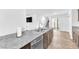 Modern kitchen featuring a stainless steel dishwasher and granite countertops, complemented by dark cabinets at 7017 Magenta Moon St, North Las Vegas, NV 89086
