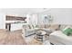 Bright open-concept living room featuring a comfortable sectional sofa, stylish decor, and plenty of natural light at 7017 Magenta Moon St, North Las Vegas, NV 89086