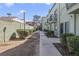 A walkway between buildings is lined with manicured bushes at 7054 Burcot Ave # G40, Las Vegas, NV 89156
