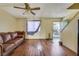 Living room featuring wood floors, ceiling fan, and street view at 7054 Burcot Ave # G40, Las Vegas, NV 89156