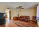 The living room features wood floors and a brown leather sofa at 7054 Burcot Ave # G40, Las Vegas, NV 89156
