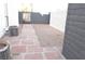 Backyard with brick pavers leading to a gated entrance of the property, air conditioning unit is also shown at 8101 Spur Ct, Las Vegas, NV 89145