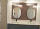 Bathroom featuring double vanity with marble countertop, modern mirrors, and updated cabinets at 8101 Spur Ct, Las Vegas, NV 89145