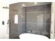 Elegant bathroom featuring a soaking tub, black marble tile, and modern fixtures at 8101 Spur Ct, Las Vegas, NV 89145