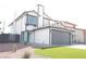 Two-story home with gray garage door, artificial turf, and desert landscaping at 8101 Spur Ct, Las Vegas, NV 89145
