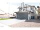 View of the exterior showcasing a modern home with gray garage door and white siding, plus a unique roof at 8101 Spur Ct, Las Vegas, NV 89145