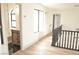 Bright hallway with wood floors leads to bathroom with granite counters and barn door closet at 8101 Spur Ct, Las Vegas, NV 89145