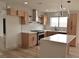 Gorgeous kitchen with stainless steel appliances, white quartz countertops, stylish light fixtures and open shelving at 8101 Spur Ct, Las Vegas, NV 89145