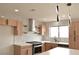 Bright kitchen featuring stainless steel appliances, quartz countertops, and light wood cabinets at 8101 Spur Ct, Las Vegas, NV 89145