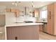 Modern kitchen with an island, stainless steel appliances, stylish cabinets, and chic lighting at 8101 Spur Ct, Las Vegas, NV 89145