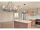 Open-concept kitchen with island, modern lighting, and stainless steel appliances at 8101 Spur Ct, Las Vegas, NV 89145