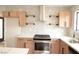 Beautiful kitchen with stainless steel appliances, open shelving, light-colored wood cabinets, and quartz countertops at 8101 Spur Ct, Las Vegas, NV 89145