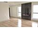Spacious living room with sleek hardwood floors and modern fireplace between bright windows at 8101 Spur Ct, Las Vegas, NV 89145