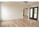 Bright living room featuring elegant hardwood floors, recessed lighting, and entry to multiple rooms at 8101 Spur Ct, Las Vegas, NV 89145
