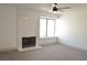 Bright living room features marble fireplace, ceiling fan, neutral carpet, and large window at 8101 Spur Ct, Las Vegas, NV 89145