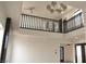 Bright loft area with a dark railing, ceiling fans and modern lighting offering a view of downstairs at 8101 Spur Ct, Las Vegas, NV 89145