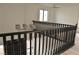 Staircase with dark railings, contemporary lighting, and views of the lower level at 8101 Spur Ct, Las Vegas, NV 89145