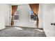 Bright bedroom featuring two windows with curtains, neutral walls, and cozy carpeting for maximum comfort at 9050 W Tropicana Ave # 1009, Las Vegas, NV 89147