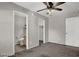 Neutral bedroom includes ceiling fan, doors to a walk-in closet and en suite bathroom at 9050 W Tropicana Ave # 1009, Las Vegas, NV 89147