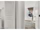 View into bedroom from doorway with a window and neutral carpet at 9050 W Tropicana Ave # 1009, Las Vegas, NV 89147