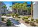 Beautifully landscaped courtyard featuring mature trees, verdant shrubs, and pathways at 9050 W Tropicana Ave # 1009, Las Vegas, NV 89147