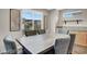 Dining room with a large wooden table, comfortable upholstered chairs, and natural light at 9050 W Tropicana Ave # 1009, Las Vegas, NV 89147