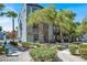 Exterior showcases lovely greenery, modern gray paint, and an inviting walkway to the units at 9050 W Tropicana Ave # 1009, Las Vegas, NV 89147