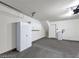 A clean garage featuring gray floors, white walls, and storage cabinets, ideal for organization and utility at 9050 W Tropicana Ave # 1009, Las Vegas, NV 89147