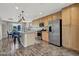 Open concept kitchen features modern appliances, large island, and hardwood floors at 9050 W Tropicana Ave # 1009, Las Vegas, NV 89147