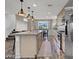 Kitchen features a large island with barstool seating, stainless steel appliances and hardwood floors at 9050 W Tropicana Ave # 1009, Las Vegas, NV 89147