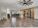 Open-concept living space with modern kitchen, dining area, and sleek hardwood floors at 9050 W Tropicana Ave # 1009, Las Vegas, NV 89147