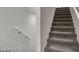 Carpeted stairs with white wall with handrail providing safe access to upper or lower level at 9050 W Tropicana Ave # 1009, Las Vegas, NV 89147