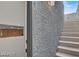 Modern stairway with gray accent wall and a glimpse into a light wood kitchen at 9050 W Tropicana Ave # 1009, Las Vegas, NV 89147