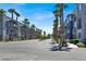 Street view of modern townhomes with palm trees, offering a glimpse of community living at 9050 W Tropicana Ave # 1009, Las Vegas, NV 89147