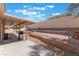 This backyard features a large covered patio, brick accents, and tiered landscaping at 1010 Armillaria St, Henderson, NV 89011