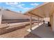 This backyard features a large covered patio, brick accents, and tiered landscaping at 1010 Armillaria St, Henderson, NV 89011