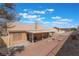 Landscaped backyard featuring a covered patio with elegant pavers at 1010 Armillaria St, Henderson, NV 89011