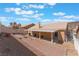 Expansive backyard featuring a covered patio and a stone pathway at 1010 Armillaria St, Henderson, NV 89011