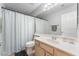 Well-lit bathroom featuring a vanity with a large mirror and tile floors at 1010 Armillaria St, Henderson, NV 89011