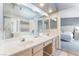 Bathroom featuring double sinks, a large mirror, and tile floors at 1010 Armillaria St, Henderson, NV 89011