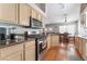 Well-equipped kitchen featuring granite countertops, stainless steel appliances, and wood floors at 1010 Armillaria St, Henderson, NV 89011